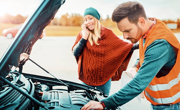 istockphoto-626782286-612×612 Couple on the road having problem with a car. They calling for help by mobile phone. Broken down car on the road. Traveling problem.